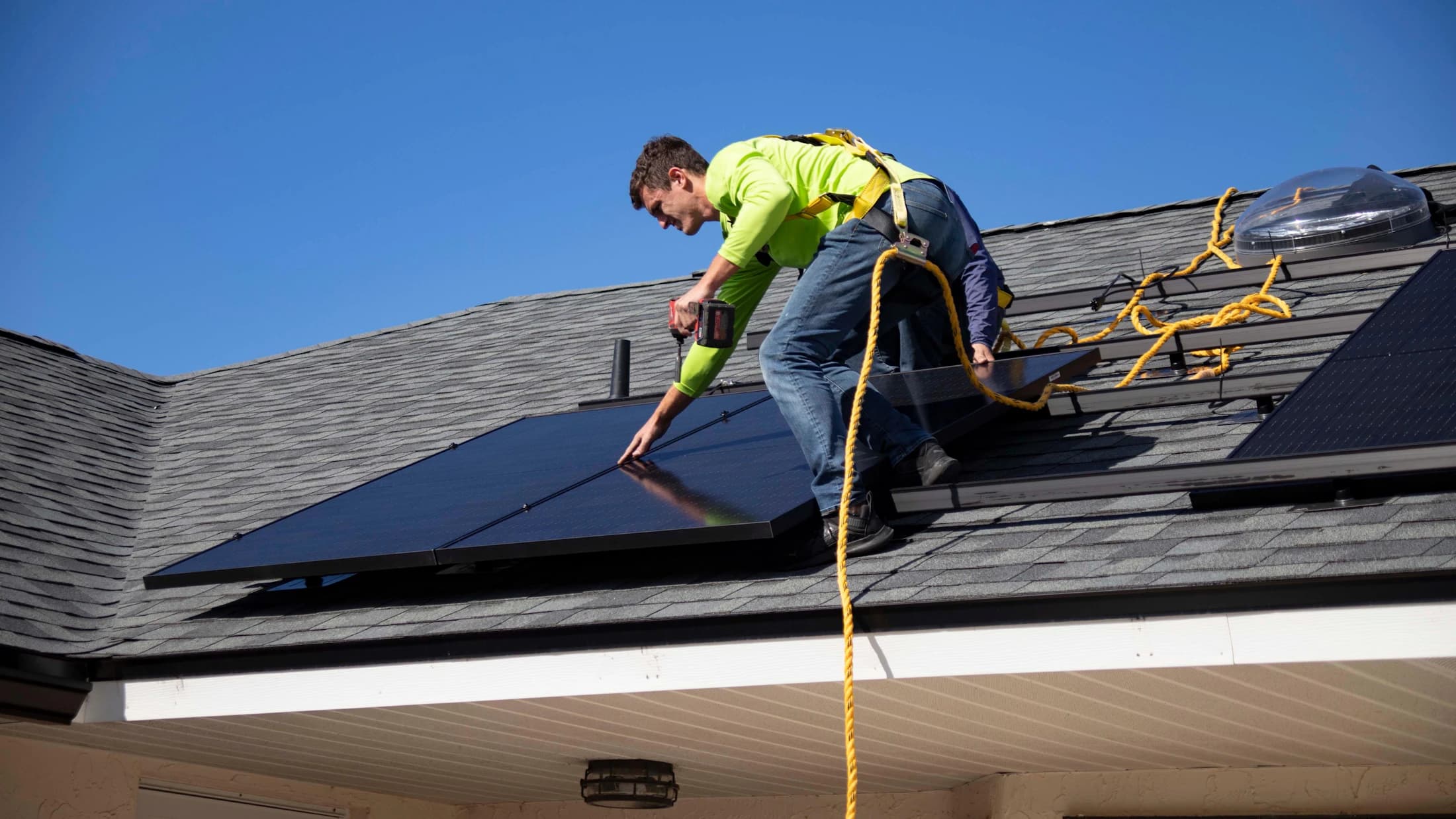 Solar installer working on a residential rooftop array